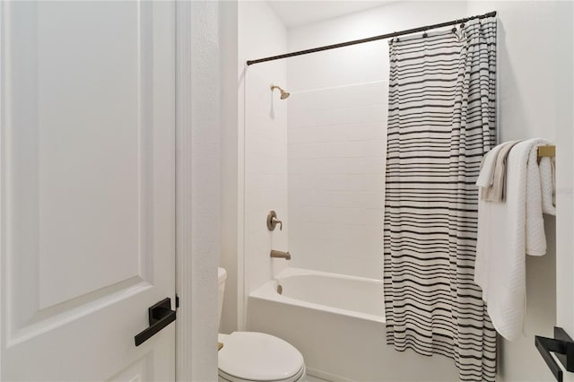 bathroom with shower / bath combo with shower curtain and toilet