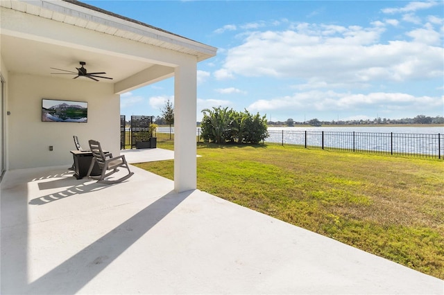 view of patio / terrace with ceiling fan and a water view