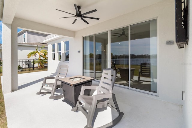 view of patio with ceiling fan and a fire pit