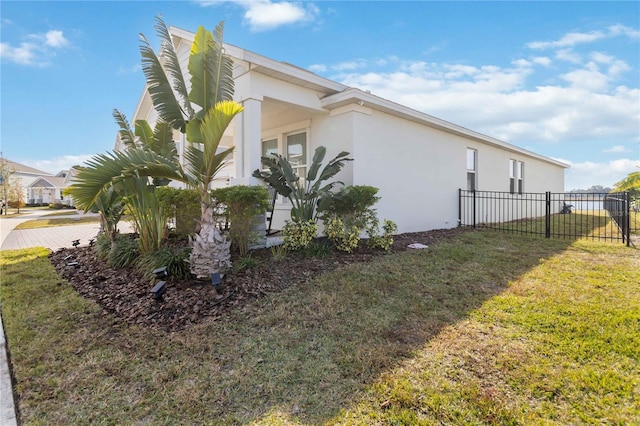 view of side of home featuring a lawn