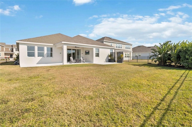 rear view of house with a patio area and a yard