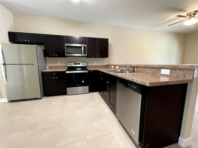 kitchen featuring ceiling fan, light tile patterned floors, appliances with stainless steel finishes, and sink