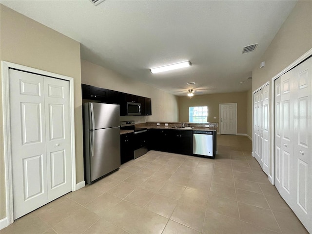 kitchen with sink, light tile patterned floors, and stainless steel appliances