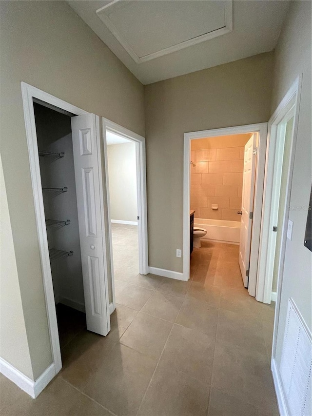 hall featuring light tile patterned floors