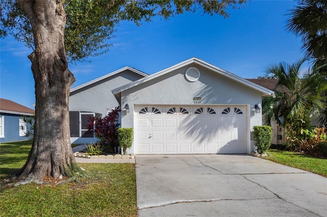 ranch-style house featuring a garage and a front yard