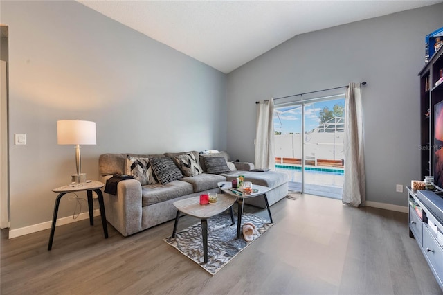 living room with lofted ceiling and hardwood / wood-style floors