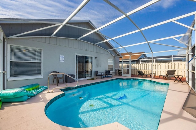 view of pool with a lanai and a patio