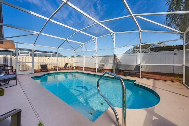 view of swimming pool featuring a lanai and a patio