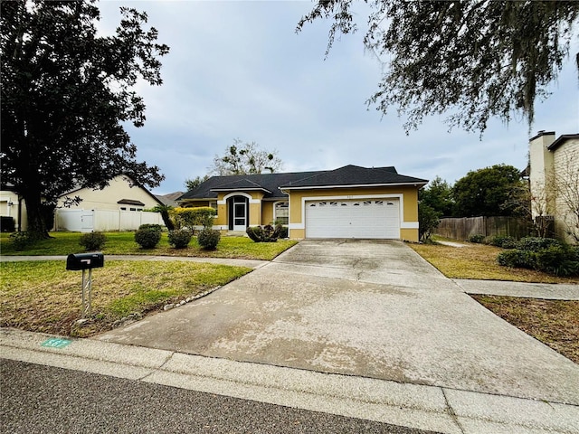 ranch-style house featuring a front lawn and a garage