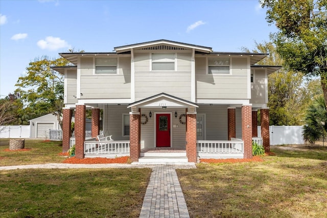 view of front of house with covered porch, fence, and a front yard