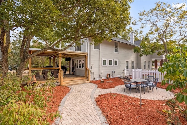 back of house with a patio and fence