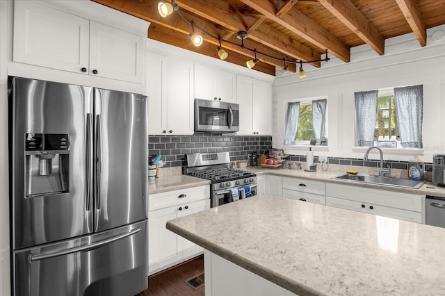 kitchen with stainless steel appliances, decorative backsplash, wood ceiling, a sink, and beamed ceiling