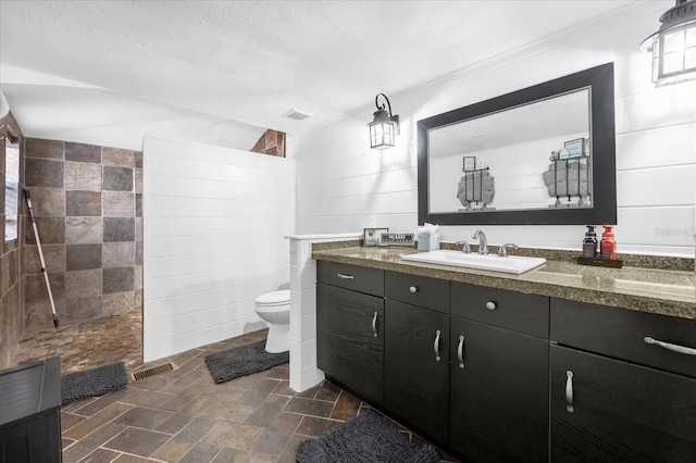 full bathroom featuring a walk in shower, toilet, vanity, and visible vents