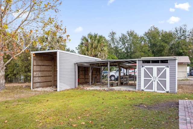 view of pole building featuring a carport, a lawn, and fence