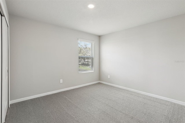 unfurnished bedroom featuring carpet floors, a closet, and baseboards