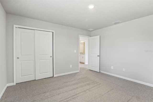 unfurnished bedroom featuring carpet, visible vents, and baseboards