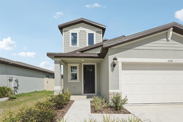 traditional home with an attached garage and stucco siding