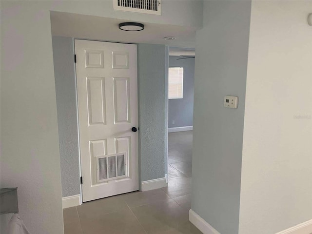 corridor with light tile patterned floors