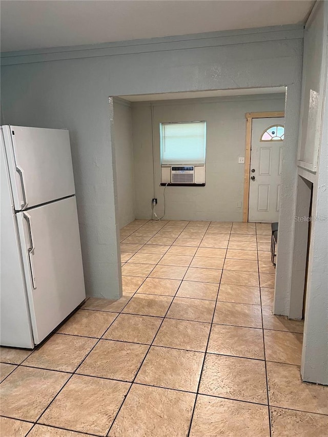 kitchen with crown molding, light tile patterned floors, cooling unit, and white refrigerator