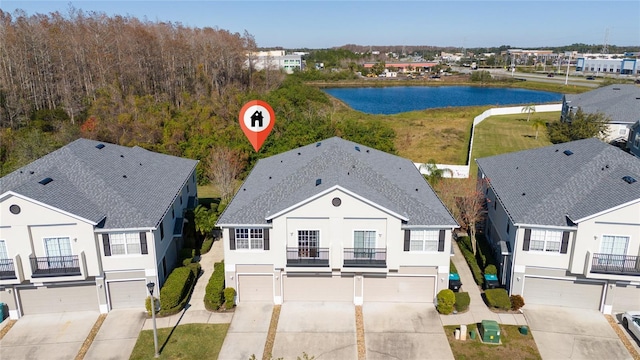 birds eye view of property with a water view