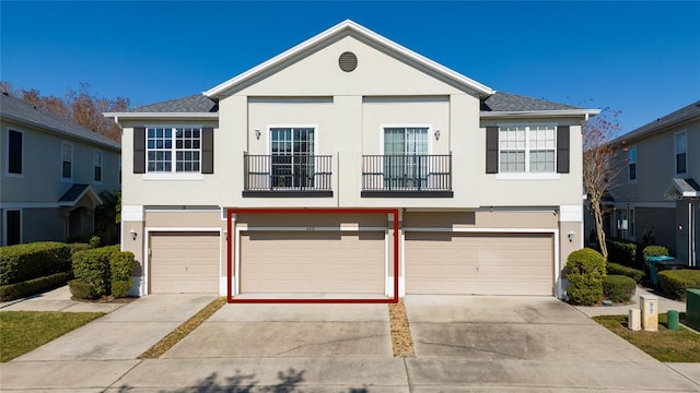 view of front facade with a garage and a balcony