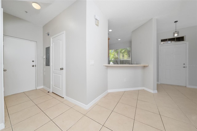 corridor with light tile patterned flooring and electric panel