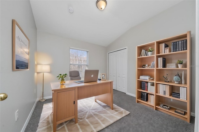 carpeted office space featuring lofted ceiling