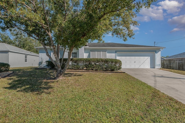 ranch-style house featuring a garage and a front yard