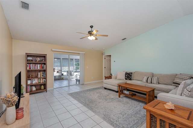 living room featuring ceiling fan, light tile patterned floors, and lofted ceiling