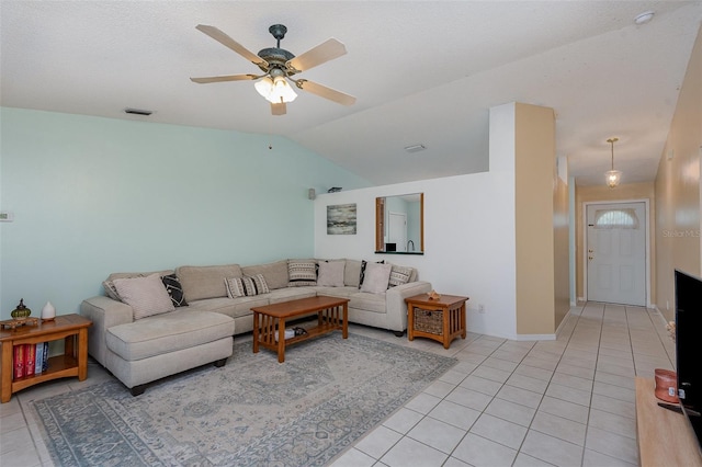 living room with ceiling fan, light tile patterned flooring, and lofted ceiling