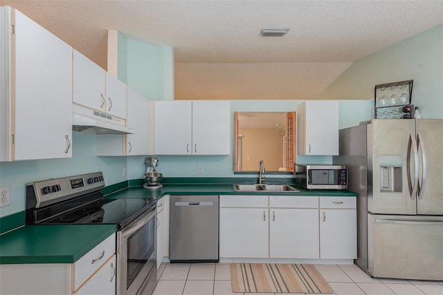 kitchen with appliances with stainless steel finishes, sink, white cabinetry, and a textured ceiling