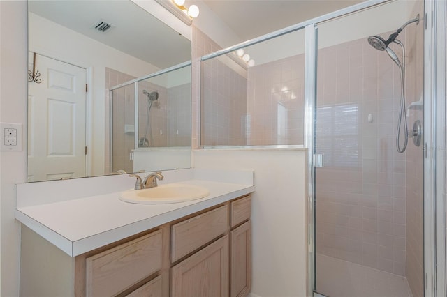 bathroom featuring walk in shower and vanity