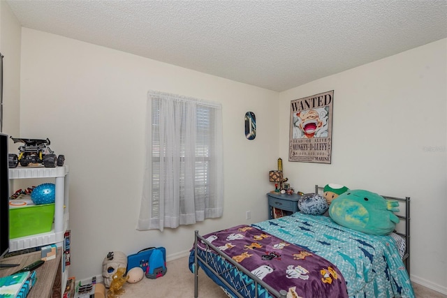 bedroom featuring carpet and a textured ceiling