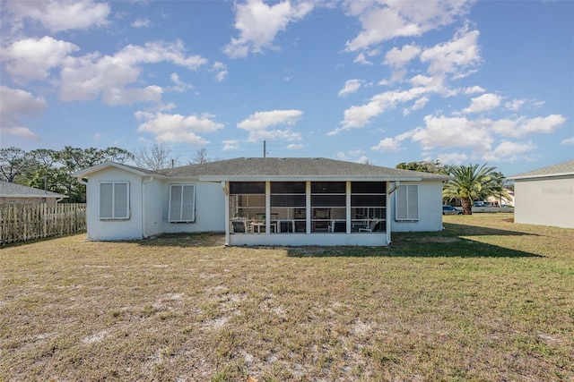 back of property featuring a yard and a sunroom