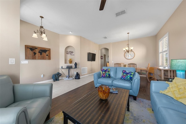 living room with hardwood / wood-style flooring and a notable chandelier