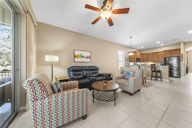 tiled living room featuring ceiling fan