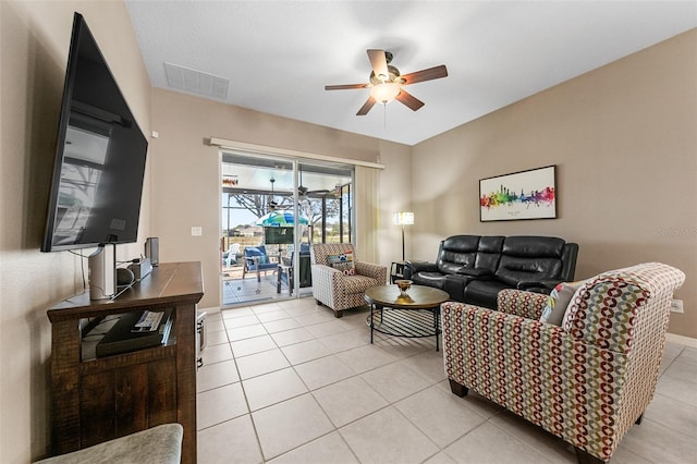 tiled living room with ceiling fan