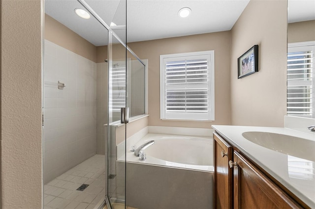 bathroom featuring vanity and separate shower and tub