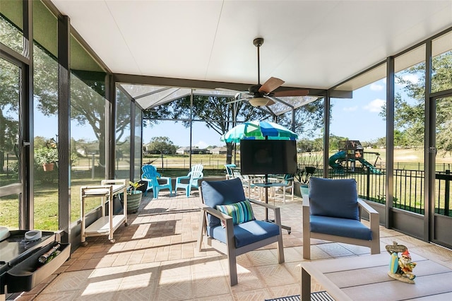 sunroom featuring ceiling fan