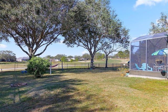 view of yard with glass enclosure