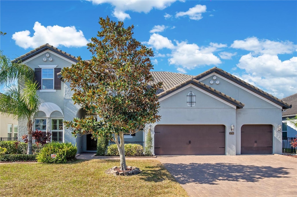 mediterranean / spanish home with a front lawn