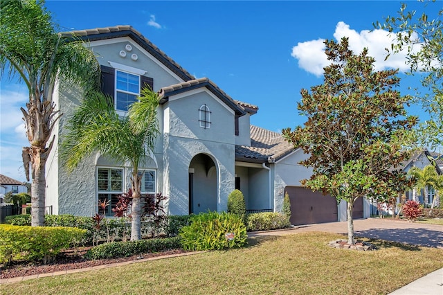 mediterranean / spanish-style house with a front yard and a garage