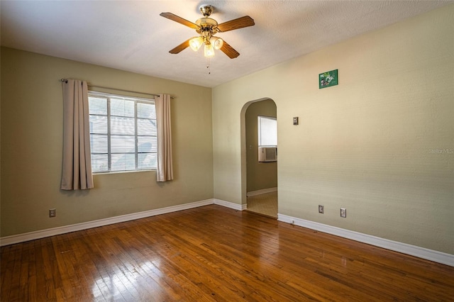 spare room with ceiling fan, dark wood-type flooring, and a textured ceiling