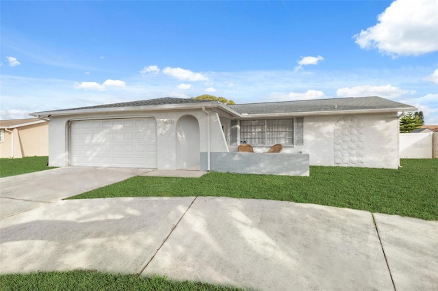 single story home featuring a garage and a front yard