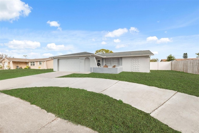 ranch-style home featuring a garage and a front yard