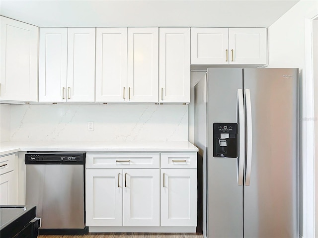 930 Lewis Dr, Daytona Beach, FL 32117 - kitchen featuring light countertops, white cabinetry, and stainless steel appliances