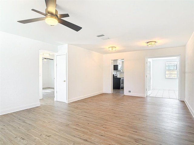 930 Lewis Dr, Daytona Beach, FL 32117 - unfurnished living room with light wood-type flooring, ceiling fan, baseboards, and visible vents