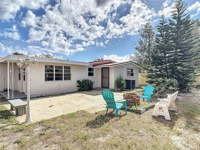 930 Lewis Dr, Daytona Beach, FL 32117 - back of property with a patio area, a fire pit, and central air condition unit