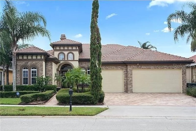 mediterranean / spanish house with a garage