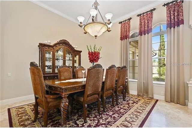 dining space featuring a wealth of natural light, ornamental molding, and a notable chandelier